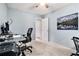 Office/bedroom with light blue walls, carpet flooring, and desk setup at 265 Lee River Cv, Suwanee, GA 30024