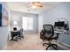 Office/bedroom with light blue walls, carpet flooring, and desk setup at 265 Lee River Cv, Suwanee, GA 30024