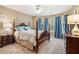 Cozy bedroom featuring a four-poster bed, bay window, and carpet flooring at 265 Lee River Cv, Suwanee, GA 30024