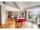 Bright dining room with hardwood floors, elegant furniture, and French doors leading to an outdoor deck at 265 Lee River Cv, Suwanee, GA 30024