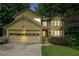 Charming two-story home featuring a two-car garage, lush landscaping, and a welcoming front entrance at 265 Lee River Cv, Suwanee, GA 30024