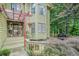 Inviting front porch with stone accents, wood railings, and decorative plants, creating a cozy entry at 265 Lee River Cv, Suwanee, GA 30024