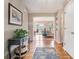 Inviting hallway featuring hardwood floors, a console table with decor, and an open view to living spaces at 265 Lee River Cv, Suwanee, GA 30024