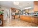 Bright kitchen features stainless steel appliances, custom cabinets, and an eat-in island at 265 Lee River Cv, Suwanee, GA 30024