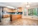 Spacious kitchen with wood cabinets, tile flooring, and a breakfast nook with ample natural light at 265 Lee River Cv, Suwanee, GA 30024