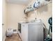 Laundry room with white washer and dryer, and shelving at 265 Lee River Cv, Suwanee, GA 30024