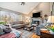 Cozy living room with a fireplace, comfortable seating, and large windows offering natural light at 265 Lee River Cv, Suwanee, GA 30024