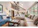 Spacious living room with vaulted ceilings, hardwood floors, and abundant natural light from large windows at 265 Lee River Cv, Suwanee, GA 30024