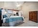 Spacious main bedroom with vaulted ceilings, a fireplace, and large windows at 265 Lee River Cv, Suwanee, GA 30024