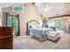 Spacious main bedroom with vaulted ceilings, windows, a fireplace, and a sitting area at 265 Lee River Cv, Suwanee, GA 30024