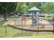 Community playground with modern play equipment and mature shade trees at 265 Lee River Cv, Suwanee, GA 30024