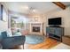 Cozy sitting area with a fireplace, hardwood floors, and large window at 265 Lee River Cv, Suwanee, GA 30024