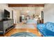 Cozy sitting area with a fireplace, hardwood floors, and access to the main bedroom at 265 Lee River Cv, Suwanee, GA 30024
