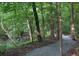 Scenic community walking trail winding through a lush wooded area at 265 Lee River Cv, Suwanee, GA 30024