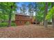 View of the house from the backyard features a deck, large windows, and privacy fencing at 3007 Manning Dr, Marietta, GA 30062