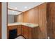Bar area features wooden paneling, cabinets, and a sink, complete with a mini fridge for convenience at 3007 Manning Dr, Marietta, GA 30062