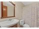 Cozy bathroom featuring a classic sink with a wooden vanity and a toilet with a floral shower curtain at 3007 Manning Dr, Marietta, GA 30062