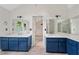 Well-lit bathroom with double sink vanity with blue cabinets at 3007 Manning Dr, Marietta, GA 30062