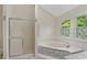 Bright bathroom with a decorative tiled soaking tub and separate glass-enclosed shower at 3007 Manning Dr, Marietta, GA 30062