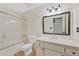 Updated bathroom featuring a shower over tub with glass enclosure, vanity and large mirror at 3007 Manning Dr, Marietta, GA 30062