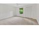 A carpeted bedroom offers a spacious closet and a window with a view of the surrounding greenery at 3007 Manning Dr, Marietta, GA 30062