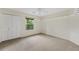 A carpeted bedroom offers a spacious closet and a window with a view of the surrounding greenery at 3007 Manning Dr, Marietta, GA 30062