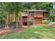 Inviting two-story home with a wood and stone facade and mature trees at 3007 Manning Dr, Marietta, GA 30062