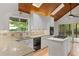 Kitchen featuring skylights, quartz countertops, white cabinetry, and stainless-steel appliances at 3007 Manning Dr, Marietta, GA 30062