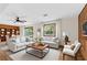 Inviting living room with stylish furniture, wood accents, and plenty of natural light coming through the windows at 3007 Manning Dr, Marietta, GA 30062