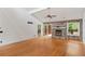 Open living room featuring vaulted ceiling, hardwood floors, a stone fireplace, and lots of natural light at 3007 Manning Dr, Marietta, GA 30062