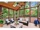Relaxing sunroom featuring wicker furniture, ceiling fan and views of the private, wooded yard at 3007 Manning Dr, Marietta, GA 30062