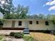 This is a home's exterior backyard showcasing a small patio, landscaping, and home siding at 3086 Lone Oak Sw Ave, Atlanta, GA 30354