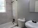 Bathroom featuring a white bathtub and shower, toilet, and sink with modern fixtures at 3086 Lone Oak Sw Ave, Atlanta, GA 30354
