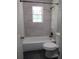 Bright bathroom featuring tiled walls, modern fixtures, and a shower-tub combination at 3086 Lone Oak Sw Ave, Atlanta, GA 30354