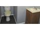 Small bathroom featuring a wood vanity with sink and toilet on a tile floor at 3086 Lone Oak Sw Ave, Atlanta, GA 30354