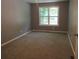 Empty bedroom with neutral carpet and a large window providing natural light at 3086 Lone Oak Sw Ave, Atlanta, GA 30354
