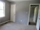 Comfortable bedroom with neutral gray walls, plush carpeting, and natural light from the window at 3086 Lone Oak Sw Ave, Atlanta, GA 30354