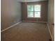 This bedroom features plush carpeting, neutral-colored walls, and a bright window for natural lighting at 3086 Lone Oak Sw Ave, Atlanta, GA 30354