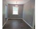 Dining area featuring hardwood floors, gray walls, a modern light fixture, and natural light at 3086 Lone Oak Sw Ave, Atlanta, GA 30354