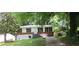 Exterior view of a house with brick detail and a well-kept lawn at 3086 Lone Oak Sw Ave, Atlanta, GA 30354