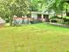 Classic home with a spacious green lawn and mature trees, ideal for outdoor enjoyment at 3086 Lone Oak Sw Ave, Atlanta, GA 30354