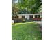 Traditional single-story home with dark shutters, brick accents, and a landscaped front yard at 3086 Lone Oak Sw Ave, Atlanta, GA 30354