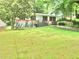 Charming home featuring a well-maintained front yard with mature trees, picnic table, and a classic exterior at 3086 Lone Oak Sw Ave, Atlanta, GA 30354