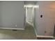 A hallway with neutral paint, carpet and hard flooring, and a view of multiple doors at 3086 Lone Oak Sw Ave, Atlanta, GA 30354