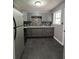 Well-lit kitchen featuring gray cabinets, tile backsplash, stainless steel appliances, and dark tile flooring at 3086 Lone Oak Sw Ave, Atlanta, GA 30354