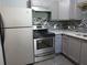 The updated kitchen includes modern stainless steel appliances and a stylish tile backsplash at 3086 Lone Oak Sw Ave, Atlanta, GA 30354