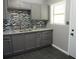 Kitchen featuring modern cabinets, granite countertops, mosaic backsplash, and slate floors at 3086 Lone Oak Sw Ave, Atlanta, GA 30354