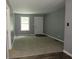 Freshly painted living room featuring updated flooring, gray walls, and abundant natural light at 3086 Lone Oak Sw Ave, Atlanta, GA 30354