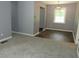 Comfortable living room featuring gray walls, carpet, and a view into an adjacent room at 3086 Lone Oak Sw Ave, Atlanta, GA 30354