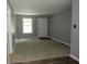 Open-concept living area with fresh gray paint, a white door, and plush carpeting at 3086 Lone Oak Sw Ave, Atlanta, GA 30354